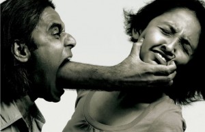 hand coming though man's mouth and grabbing woman by face