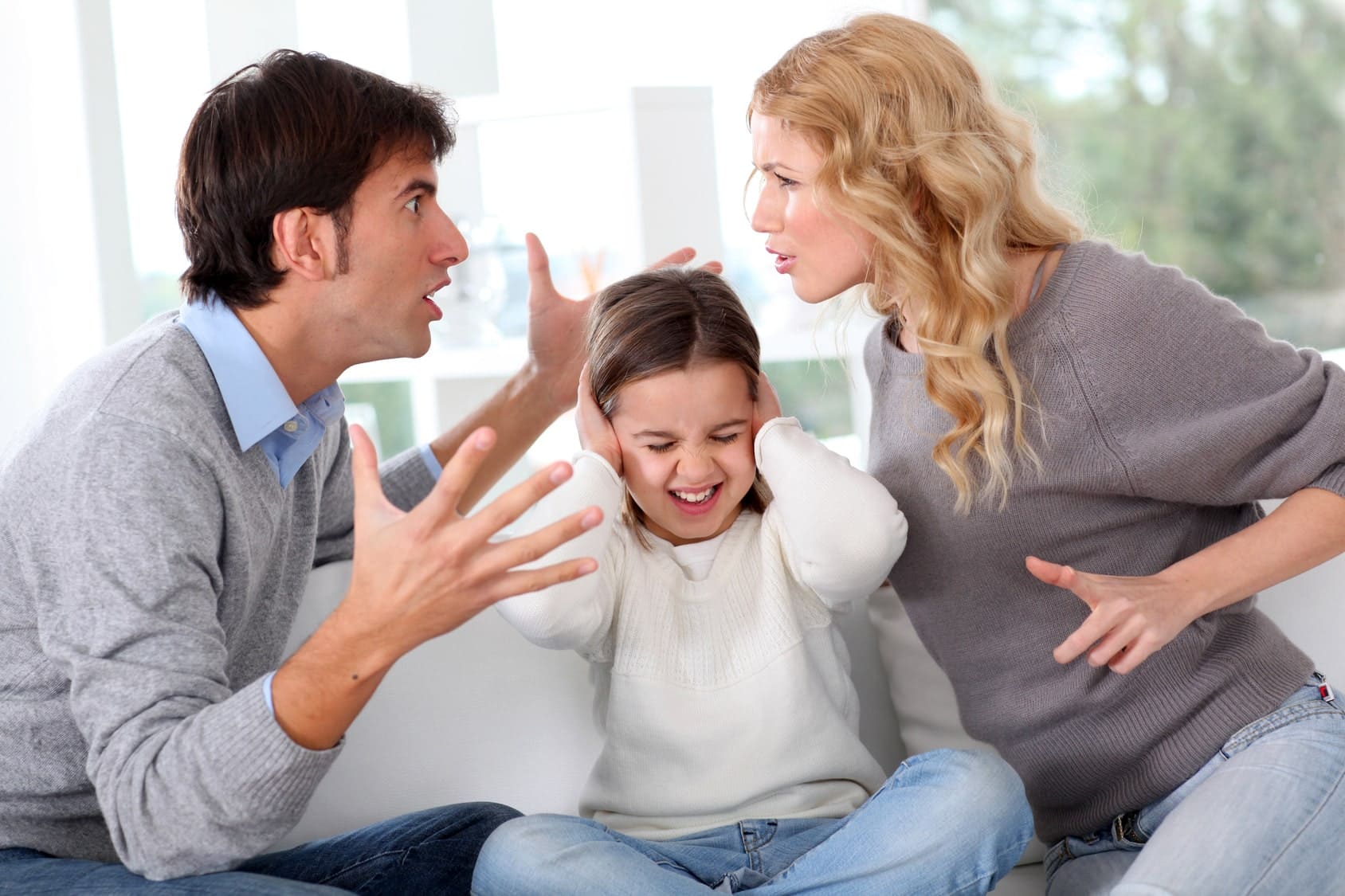 couple fighting with child in the middle