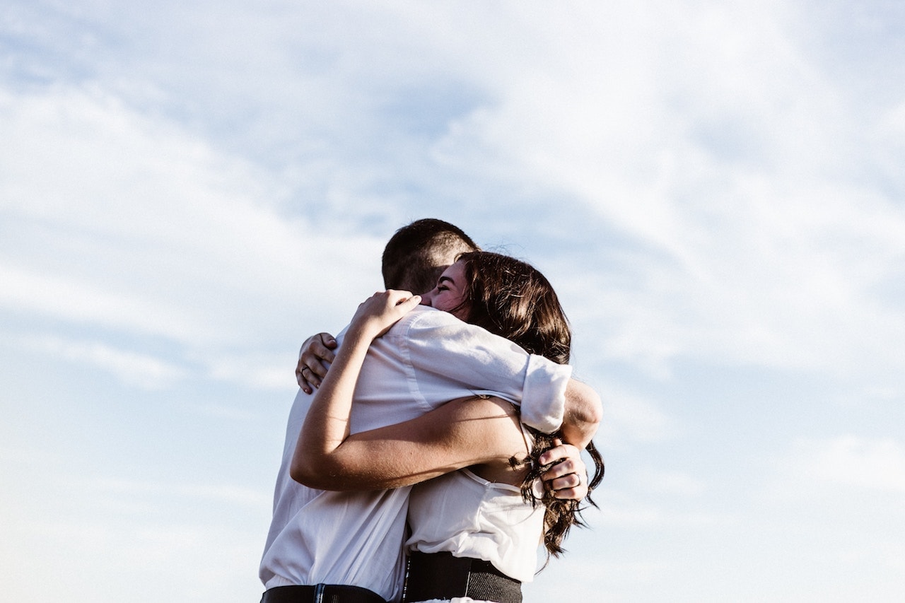 girl hugging boy tightly