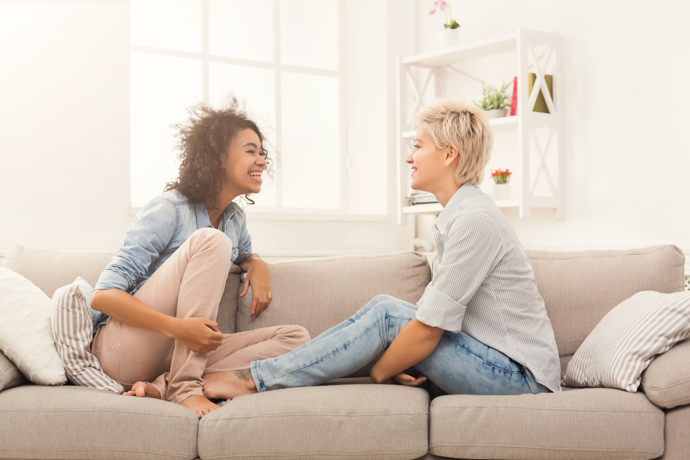 happy couple talking on sofa